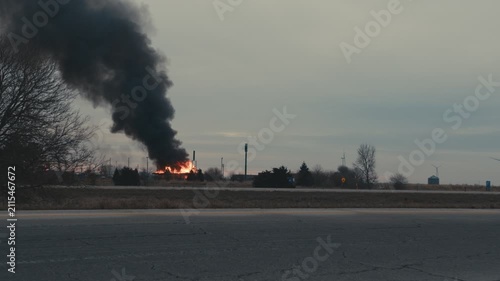 Industrial building fire producing thick black smoke