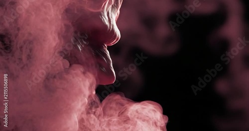 Person exhaling pink smoke abstract background