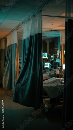 Hospital Room With Medical Equipment And Patient Silhouette Behind Curtains