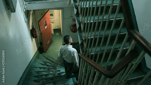 Urban Staircase Journey: Emotive Silhouette Descends Modern Interior Steps, Exploring Architectural Mystery and Creative Contrast in Environment and Design
