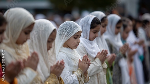 Children in white headscarves praying