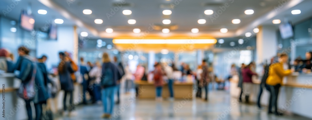 Fototapeta premium Blurred service center with staff assisting customers at counters