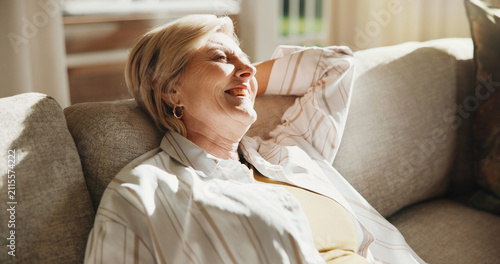 Fotografie Thinking, relax and senior woman in home for retirement, calm and break for daydream on couch