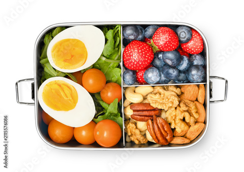 Lunch box with berries, nuts and salad on white isolated background, top view.Healthy eating and snacking concept.