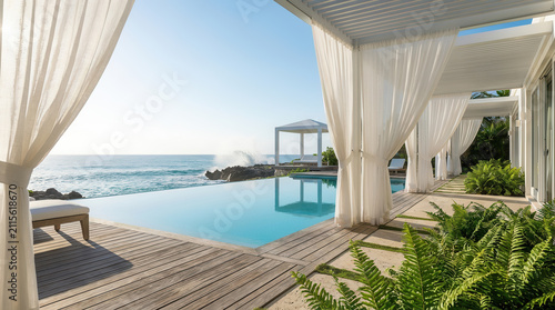 Hyper-realistic 8K architectural photography of a luxurious modern infinity pool villa overlooking a crystal-clear turquoise ocean. Minimalist white architecture with an elegant gazebo,