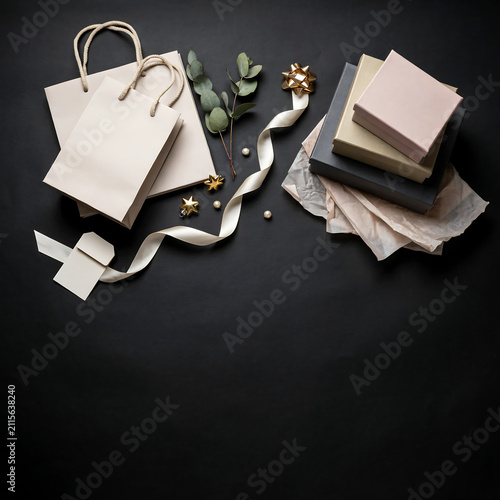 Flat lay composition of shopping bags and gift boxes with ribbons transparent background