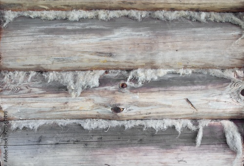 Close-up of weathered log construction with visible fibers and rough textures, showcasing natural wood grain and aged appearance.