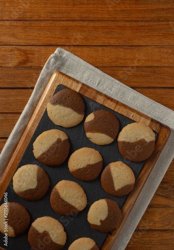 Homemade coffee and vanilla Cookie bites Home kitchen scene resting on board ready to eat on a rustic wooden table.
