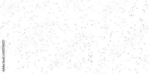 A field of small gray specks scattered across a white background.