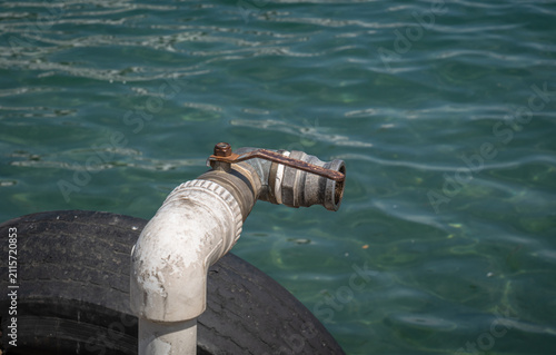 A large water valve by the sea.