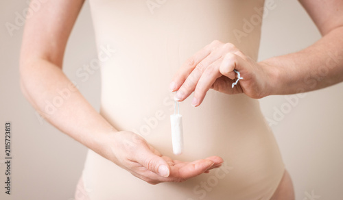 Fotografie A woman holds choice of sanitary tampons, feminine hygiene product