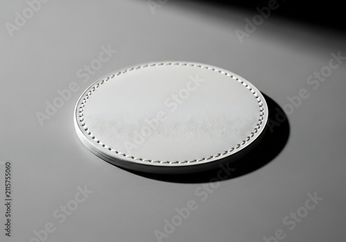 Minimalist white oval coaster with stitching detail