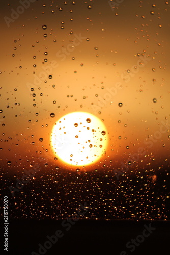 Raindrops on Window Glass During Golden Hour Sunset