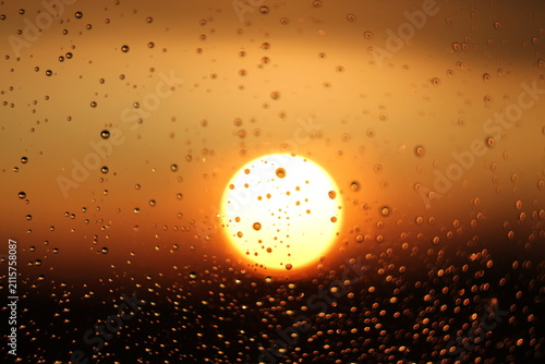 Raindrops on Window Glass During Golden Hour Sunset