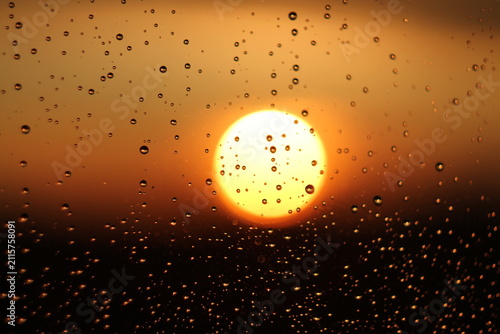 Raindrops on Window Glass During Golden Hour Sunset