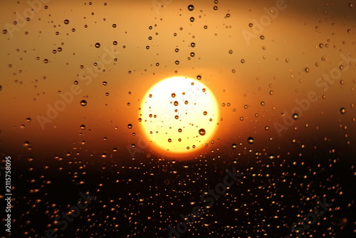 Raindrops on Window Glass During Golden Hour Sunset