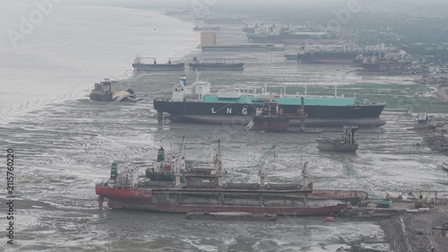 Aerial view of large cargo ships and tankers beached on the mudflats at the Ship Breakers Yard in Bhatiari, Chittagong Division, Bangladesh.