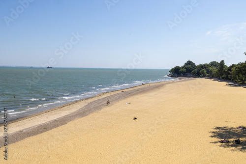 Wide sandy beach at Appley Beach in Ryde on the Isle of Wight with gentle waves along the shoreline and a peaceful summer coastline creating a relaxing seaside landscape beneath a clear blue sky