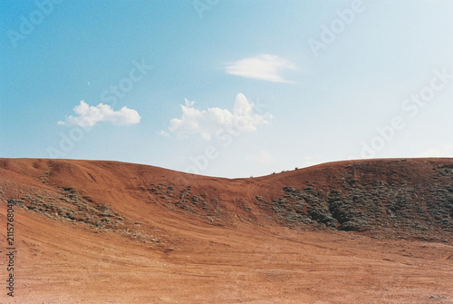 Minimalist landscape of red clay hills and blue sky in Boguty mountains, analog 35mm film photography