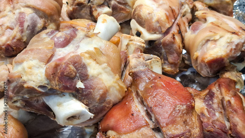 Fotografie Crispy roasted pork knuckle hocks close up details with tender meat and bone