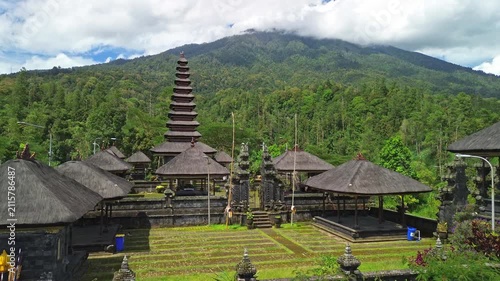 Drone push-in rising above Pura Pengubengan Balinese Hindu temple revealing Mt. Agung, Bali, Indonesia