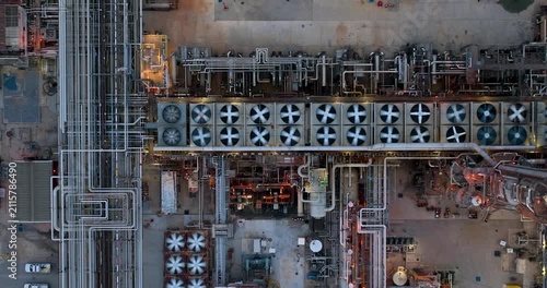 Aerial view of the industrial infrastructure and cooling fans at the Joliet oil refinery, featuring complex piping networks and metallic structures in Joliet, Illinois, United States.