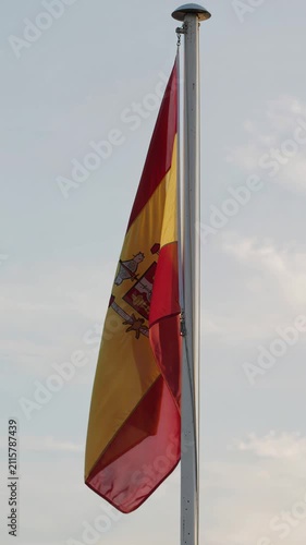 Spanish Flag Waving Against Overcast Sky, Low Angle Vertical 4K