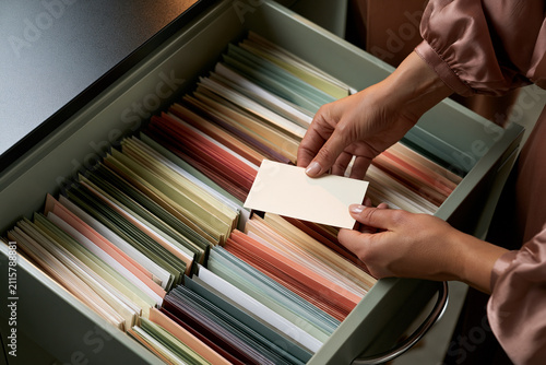 Curator auditing a color-coded seed accession drawer