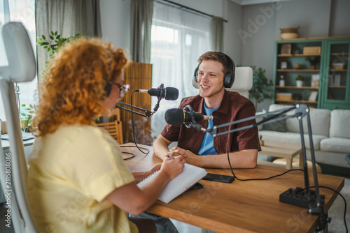 фотографія Recording new podcast episode with people interviewing in studio