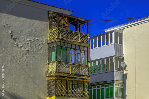 A fragment of the facade of an old apartment building on a summer day