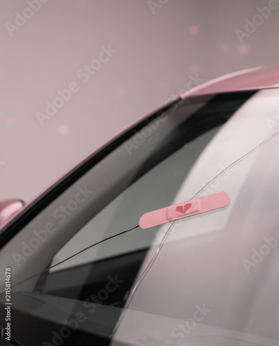 Pink Bandage on the Cracked Windshield of a Pink Car
