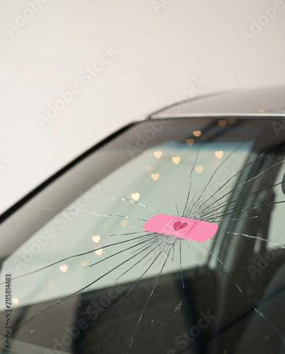 Cracked Windshield with Pink Bandage and Romantic Heart Lights
