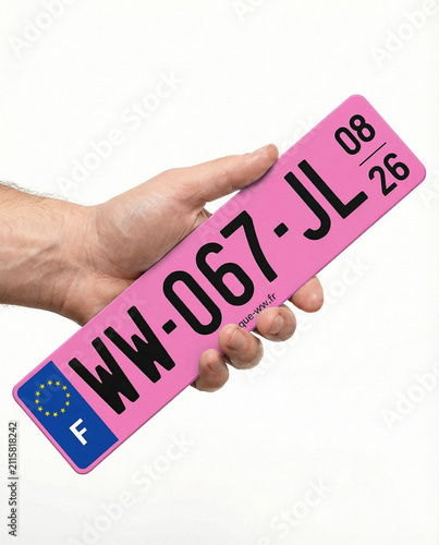 Hand Holding a Pink French Car Registration Plate
