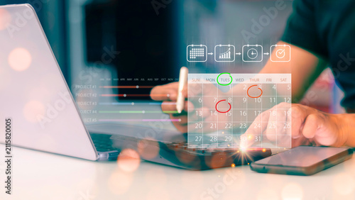 Businessman using stylus pen touching virtual calendar icon for project management planning.