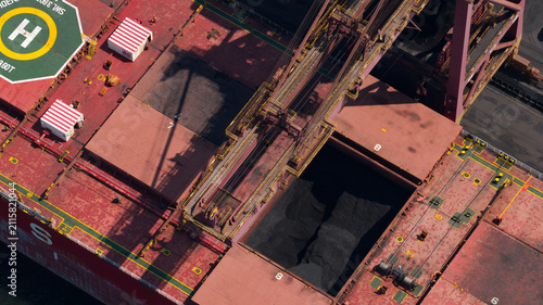 Aerial view of the Cokerie Arcelormittal facility with a bulk carrier ship being loaded with coal, cranes, and industrial infrastructure in Grande-Synthe, Hauts-de-France, France.