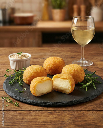 Crispy Fried Cheese Croquettes Served with a Glass of White Wine