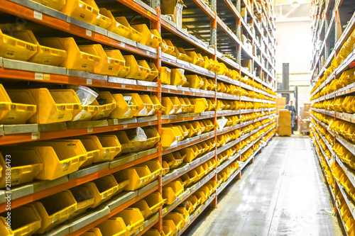Obraz na płótnie Industrial warehouse with small parts neatly stored in yellow storage bins
