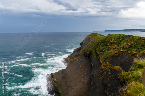 Scenic view of Cabo Mayor cliffs in Santander, Spain, with the sea and cloudy sky.