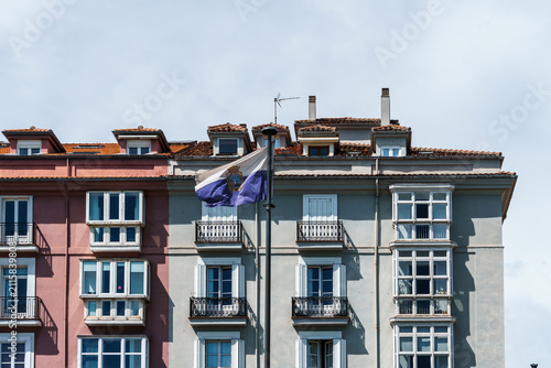 Old residential building facade in Santander, Spain, featuring balconies and dormer windows.
