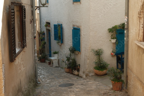 Charming old town street with stone houses and shops in Krk city