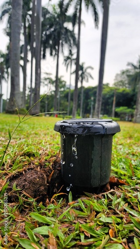 A garden drip irrigation system that waters plants at specific intervals, ensuring their water needs are met even though the public garden is exposed to the scorching tropical sun.