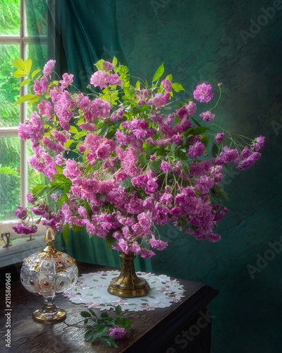 Still life with a bouquet of pink roses rambler.