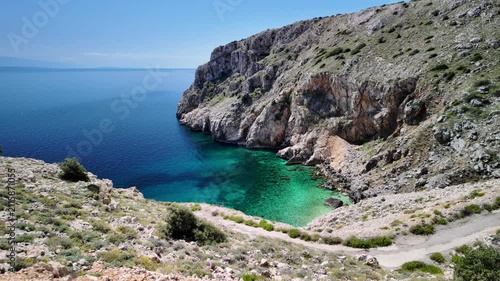 Mali Bok Beach on Cres Island, Croatia. Hidden cove with turquoise Adriatic Sea, dramatic limestone cliffs and crystal water surrounded by unspoiled Mediterranean nature in Cres Island of Croatia