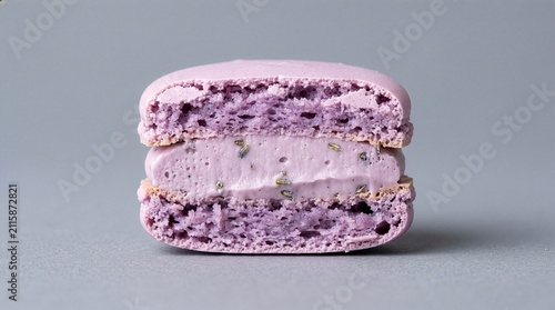 Macro cross section of purple lavender macaron with rich cream filling and dried lavender buds, minimalist aesthetic background