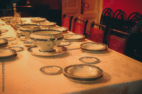 Quadro su tela Close-up of traditional dinner table set with porcelain plates and soup tureen i