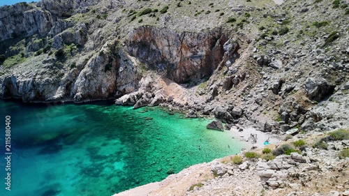 Mali Bok Beach, Cres Island, Croatia. Hidden Adriatic cove with turquoise water, rocky seabed, and steep cliffs.