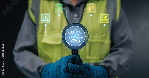 Construction collaboration concept engineer holding magnifying glass analyzing partnerships projects resources growth handshake hologram digital transformation project management B2B