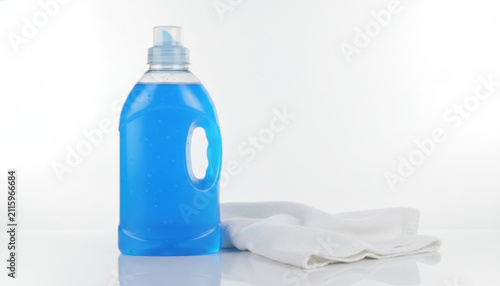Blue liquid detergent in plastic bottle with white cloth on white background