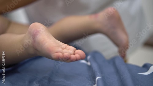 Close-up of a baby's feet during a gentle massage at home. Relaxing childcare routine promoting comfort, wellness and parent-child bonding.