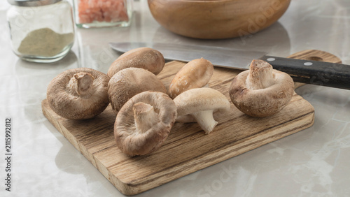 Japanese shitake on the cutting board. Fresh shitake mushrooms on the table.